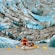 Passengers in a 12 seat canoe paddling up close to a glacier